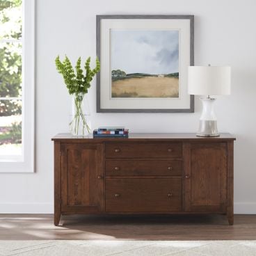 Real walnut credenza with three drawers with greenery and art for a modern dining space