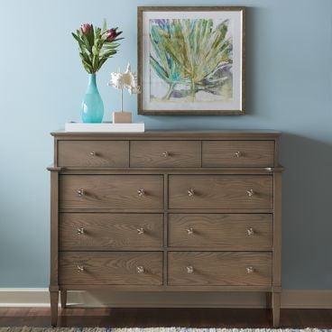 solid wood chest on chest with drawers, styled with a vase and artwork.