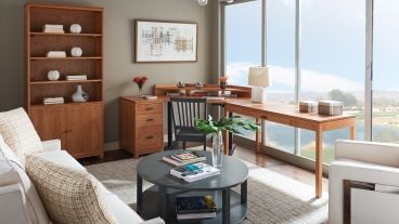 Handcrafted wooden writing desk with clean lines, a minimalist design, and a functional storage drawer, ideal for home offices or living spaces.