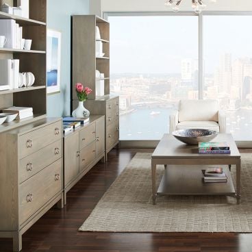 Living room showcasing wood furniture with matching bookshelves, coffee table, and sideboard.