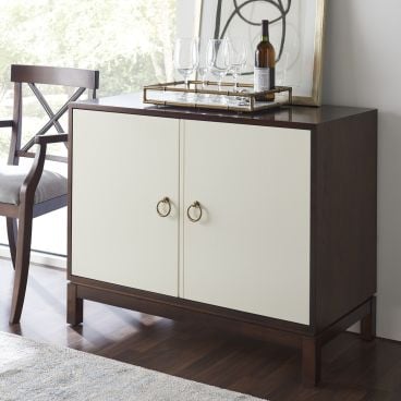 A contemporary wooden cabinet with two doors, offering concealed storage and a sleek, modern design.