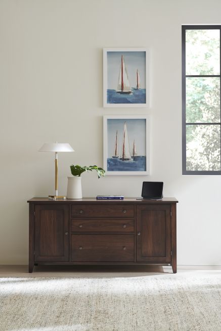 Atticus Three Drawer Credenza is shown in walnut wood.