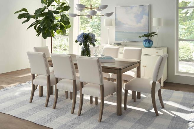 Modern dining room showcasing a wooden dining set with upholstered seating.