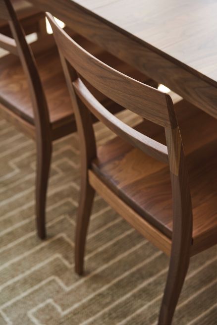 handmade walnut chair with a detail view of the back of the chair showcasing craftsmanship