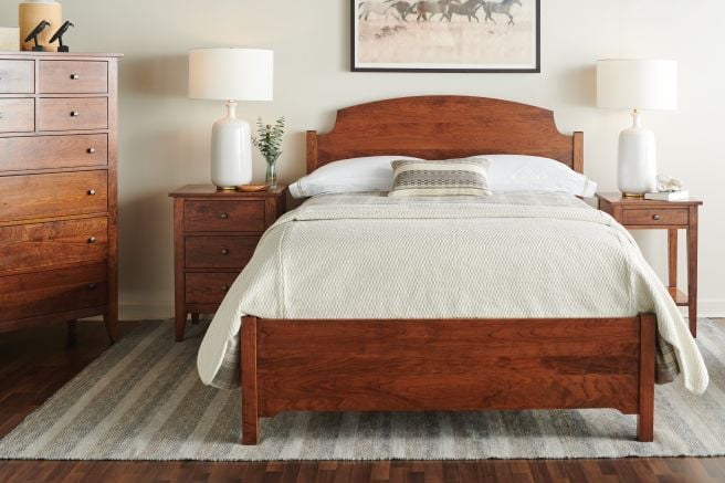 A real wood bedroom set made from Appalachian cherry hardwood, featuring an heirloom-quality bed frame, nightstands, and a spacious tall dresser.