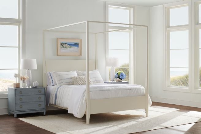 A real wood canopy bed featuring a streamlined silhouette and a sturdy hardwood frame, crafted from sustainably sourced Appalachian wood.