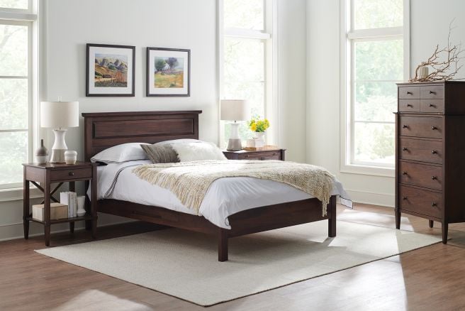 Panel storage bed crafted from Appalachian wood, styled with matching furniture in a sunlit bedroom, emphasizing natural materials and classic design.