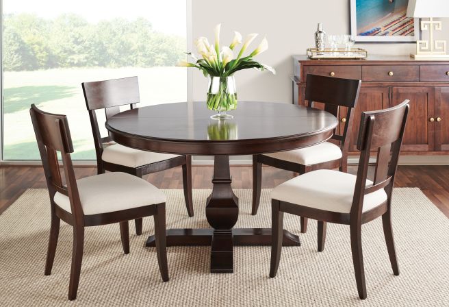 Real solid wood chairs sitting around a real wooden dining table.