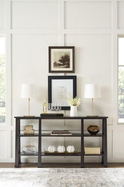 Modern wood console with stylish decor accents, featuring clean lines and a rich finish, perfect for dining spaces.