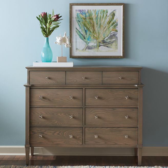 solid wood chest on chest with drawers, styled with a vase and artwork.