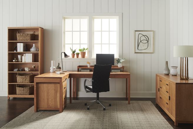 Home office with a wooden credenza, desk, and shelving unit.