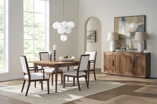 Contemporary walnut dining chairs with upholstered seats, styled in a light-filled modern dining room.