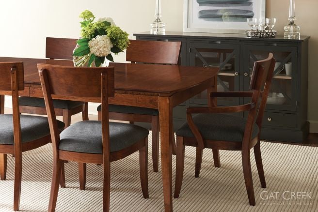 Handcrafted hardwood dining set with a rich cherry finish, paired with a sleek black glass-front buffet for a sophisticated dining space